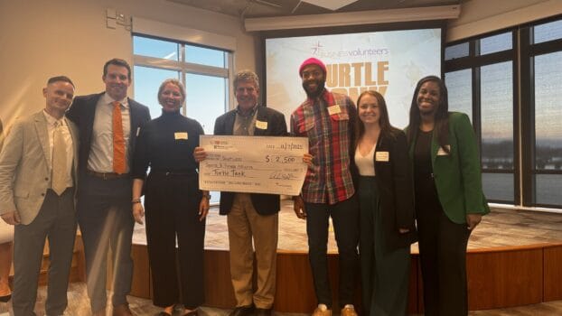 GIVE Fellows pose with the executive director of Southwest Sports & Fitness Alliance. Turtle Tank Judge Mark Jankowski holds their check for winning 3rd place.